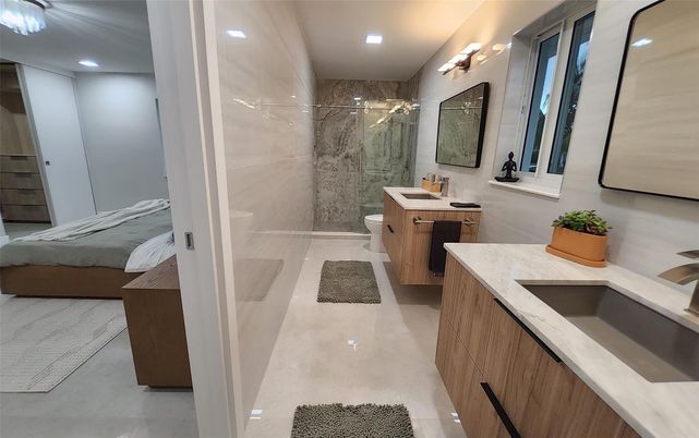 Bathroom, Dual Sink Vanities, Glass Shower, Interior, Marble Walls, Recessed Lighting