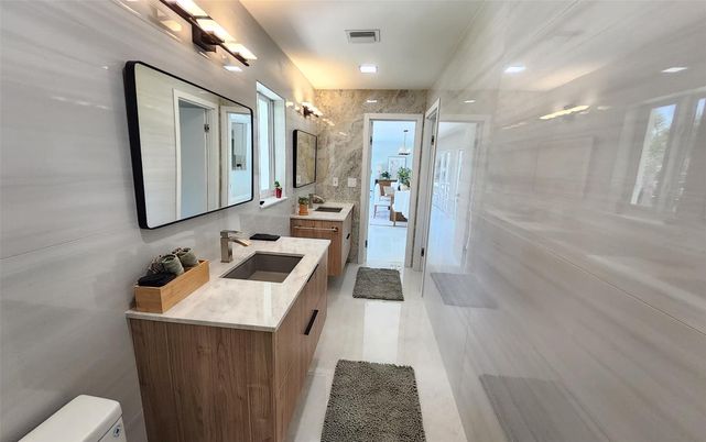 Bathroom, Dual Sink Vanities, Glass Shower, Interior, Marble Walls, Recessed Lighting