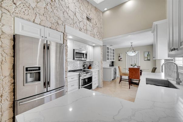 Chandelier, Dining room, Interior, Kitchen, Pendant Lights, Recessed Lighting, Stainless Steel Appliances, Stone Walls