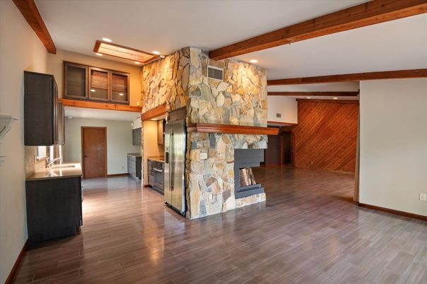 Empty room, Fireplace, Interior, Recessed Lighting, Stone Walls, Wooden Beams, Wood Texture Flooring