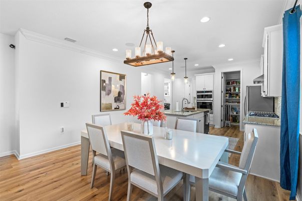 Dining room, Interior, Kitchen, Pendant Lights, Recessed Lighting, Stainless Steel Appliances, Wood Texture Flooring
