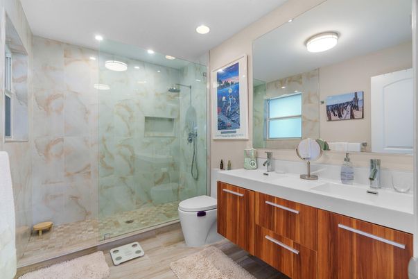 Bathroom, Dual Sink Vanities, Glass Shower, Interior, Marble Walls, Recessed Lighting, Wood Texture Flooring
