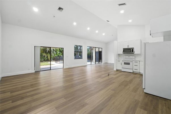 Empty room, Interior, Kitchen, Recessed Lighting, Stainless Steel Appliances, Wood Texture Flooring