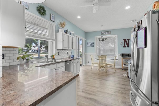 Dining room, Interior, Kitchen, Pendant Lights, Recessed Lighting, Stainless Steel Appliances, Wood Texture Flooring