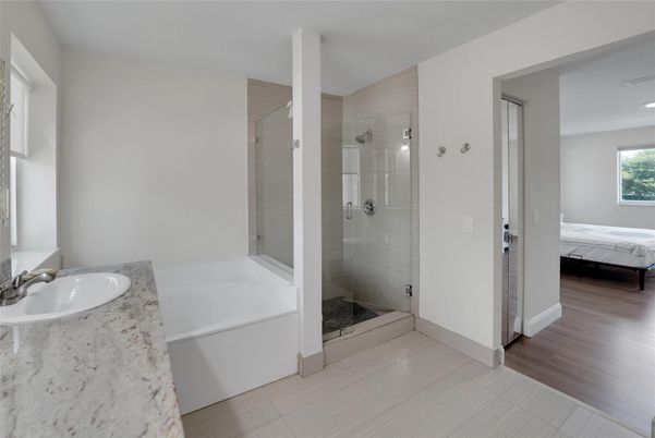 Bathroom, Dual Sink Vanities, Glass Shower, Interior, Recessed Lighting, Wood Texture Flooring