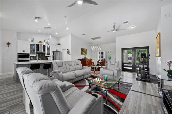 Chandelier, Dining room, Interior, Kitchen, Living room, Pendant Lights, Recessed Lighting, Stainless Steel Appliances, Wood Texture Flooring