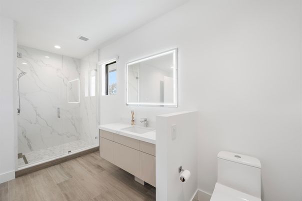 Bathroom, Dual Sink Vanities, Glass Shower, Interior, Marble Walls, Recessed Lighting, Wood Texture Flooring