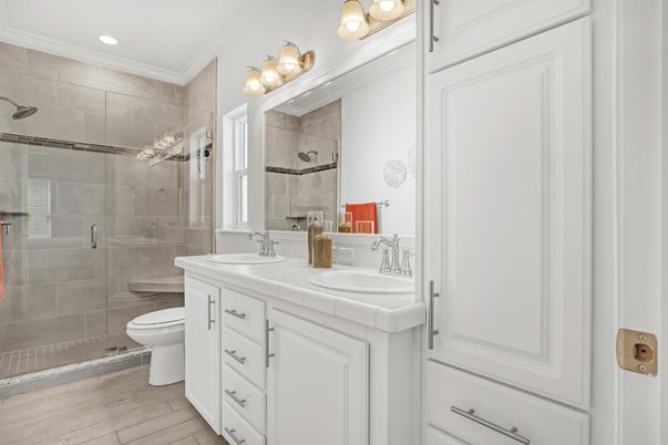 Bathroom, Dual Sink Vanities, Glass Shower, Interior, Recessed Lighting, Tile Countertops, Wood Texture Flooring