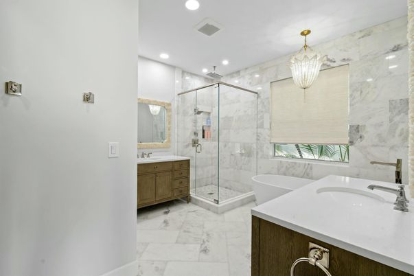 Bathroom, Chandelier, Dual Sink Vanities, Free Standing Baths, Glass Shower, Interior, Marble, Marble Walls, Recessed Lighting