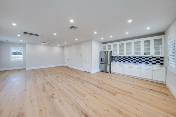 Empty room, Interior, Kitchen, Recessed Lighting, Stainless Steel Appliances, Wood Texture Flooring