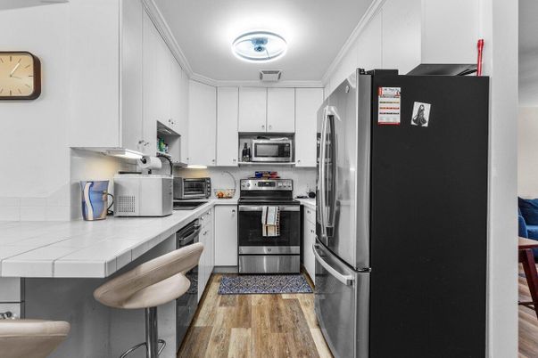 Interior, Kitchen, Stainless Steel Appliances, Tile Countertops, Wood Texture Flooring