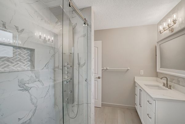 Bathroom, Dual Sink Vanities, Glass Shower, Interior, Marble Walls, Wood Texture Flooring