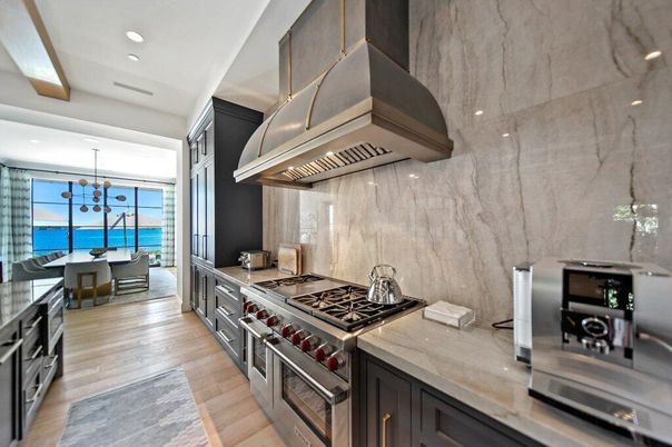 Chandelier, Dining room, Interior, Kitchen, Marble Walls, Pendant Lights, Recessed Lighting, Stainless Steel Appliances, Water, Wood Texture Flooring