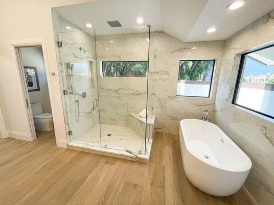 Bathroom, Free Standing Baths, Glass Shower, Interior, Marble Walls, Recessed Lighting, Wood Texture Flooring