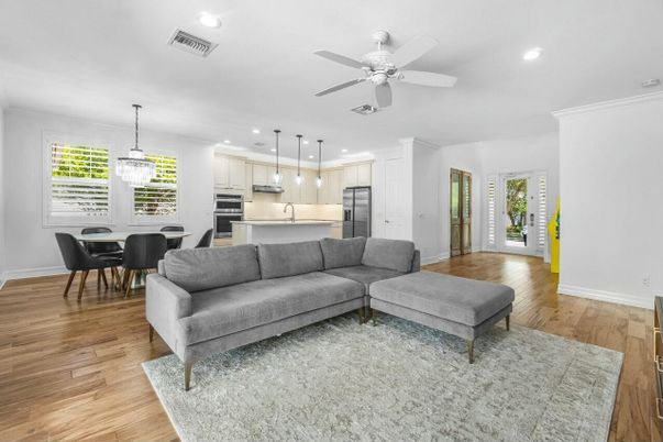 Chandelier, Dining room, Interior, Kitchen, Living room, Pendant Lights, Recessed Lighting, Stainless Steel Appliances, Wood Texture Flooring