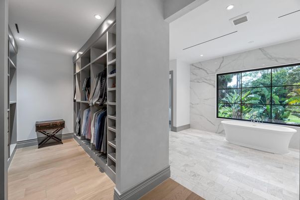 Bathroom, Free Standing Baths, Interior, Marble, Marble Walls, Recessed Lighting, Walk-in Closets, Wood Texture Flooring