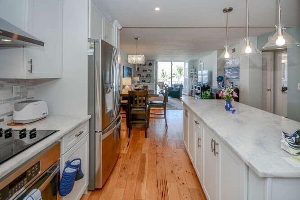 Chandelier, Dining room, Interior, Kitchen, Living room, Pendant Lights, Recessed Lighting, Stainless Steel Appliances, Wood Texture Flooring