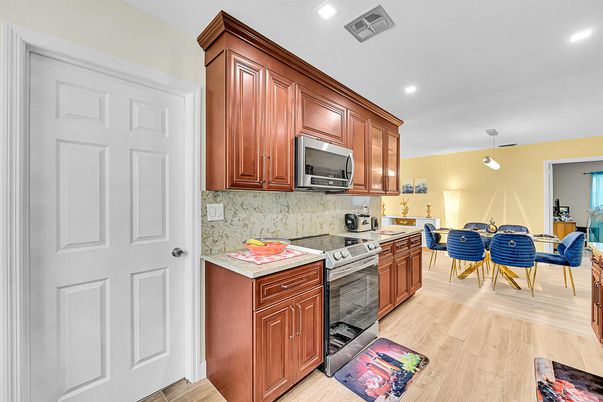 Dining room, Interior, Kitchen, Pendant Lights, Recessed Lighting, Stainless Steel Appliances, Wood Texture Flooring