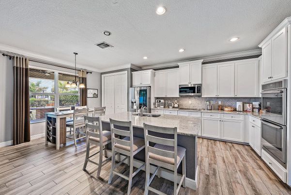 Dining room, Interior, Kitchen, Pendant Lights, Recessed Lighting, Stainless Steel Appliances, Wood Texture Flooring
