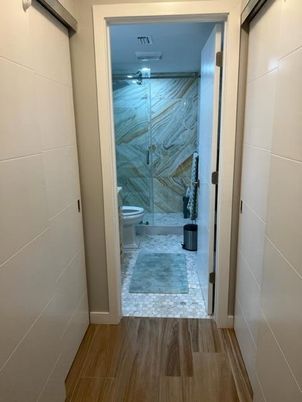Bathroom, Glass Shower, Interior, Marble Walls, Wood Texture Flooring
