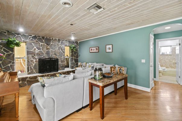 Bathroom, Fireplace, Interior, Living room, Recessed Lighting, Stone Walls, Wood Texture Flooring
