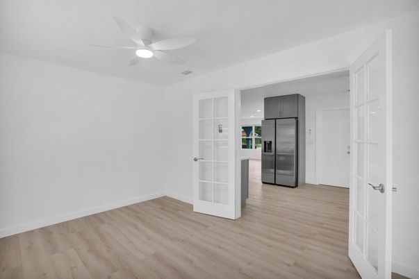 Empty room, Interior, Kitchen, Recessed Lighting, Stainless Steel Appliances, Wood Texture Flooring