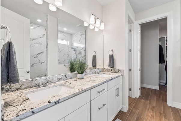 Bathroom, Dual Sink Vanities, Interior, Marble Walls, Recessed Lighting, Wood Texture Flooring