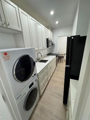 Interior, Kitchen, Recessed Lighting, Washer, Wood Texture Flooring