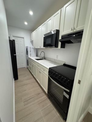 Interior, Kitchen, Recessed Lighting, Washer, Wood Texture Flooring