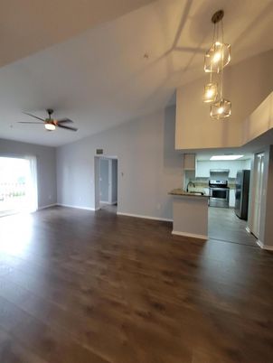 Empty room, Interior, Kitchen, Pendant Lights, Stainless Steel Appliances, Wood Texture Flooring