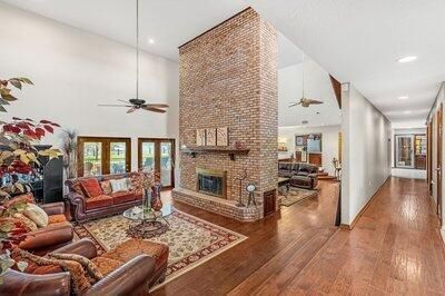 Fireplace, Interior, Living room, Recessed Lighting, Stone Walls, Wood Texture Flooring