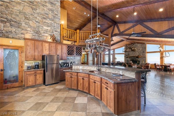 Chandelier, Dining room, Fireplace, Interior, Kitchen, Pendant Lights, Recessed Lighting, Stainless Steel Appliances, Stone Walls, Wooden Beams, Wooden Ceilings