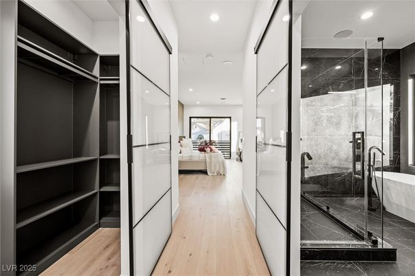 Bathroom, Bedroom, Free Standing Baths, Glass Shower, Interior, Marble Walls, Recessed Lighting, Walk-in Closets, Wood Texture Flooring