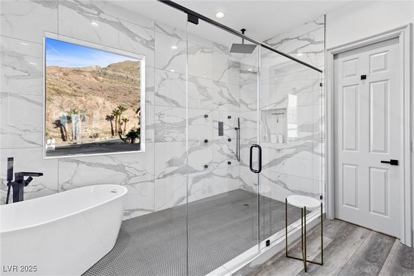 Bathroom, Free Standing Baths, Glass Shower, Interior, Marble Walls, Recessed Lighting, Wood Texture Flooring