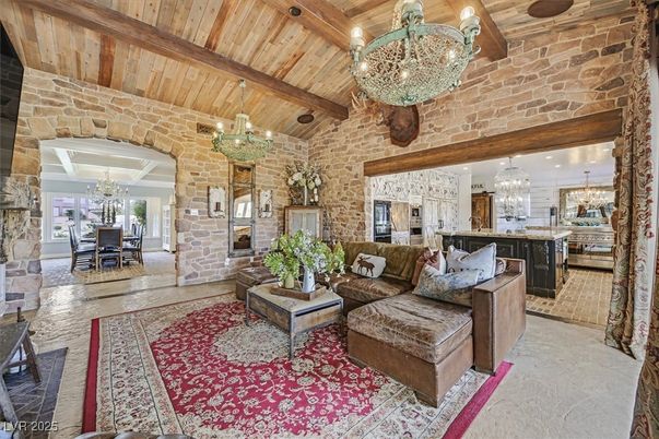 Chandelier, Dining room, Fireplace, Interior, Kitchen, Living room, Pendant Lights, Recessed Lighting, Stainless Steel Appliances, Stone Walls, Wooden Beams, Wooden Ceilings