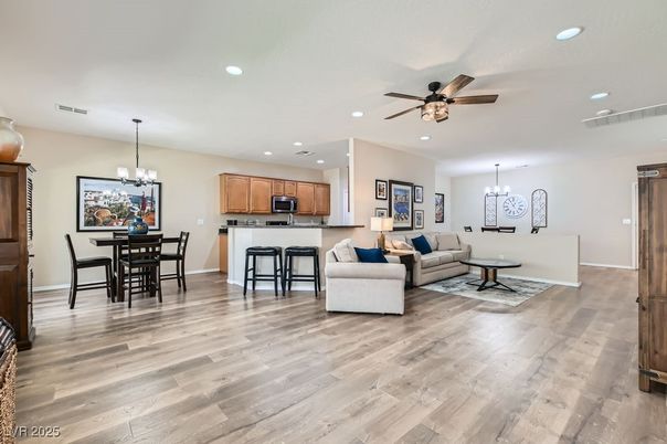 Chandelier, Dining room, Interior, Kitchen, Living room, Pendant Lights, Recessed Lighting, Stainless Steel Appliances, Wood Texture Flooring