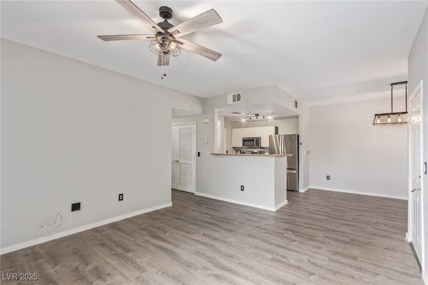 Empty room, Interior, Kitchen, Pendant Lights, Stainless Steel Appliances, Wood Texture Flooring