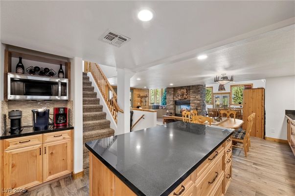 Dining room, Fireplace, Interior, Kitchen, Recessed Lighting, Stone Walls, Wood Texture Flooring