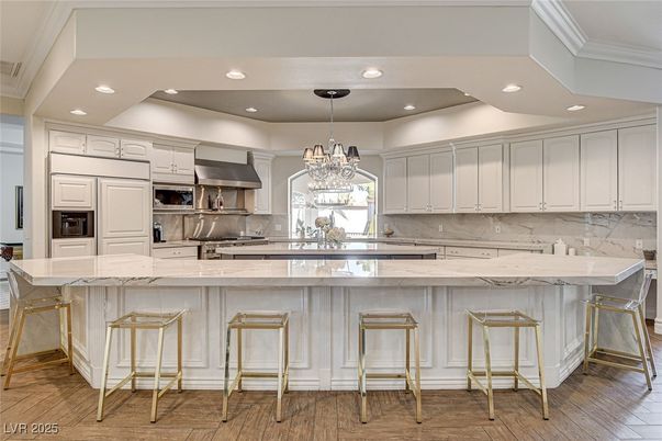 Chandelier, Interior, Kitchen, Marble Walls, Recessed Lighting, Stainless Steel Appliances, Wood Texture Flooring