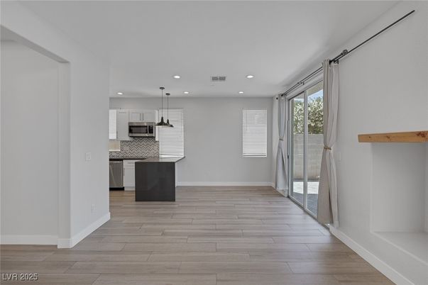 Empty room, Interior, Kitchen, Pendant Lights, Recessed Lighting, Stainless Steel Appliances, Wood Texture Flooring