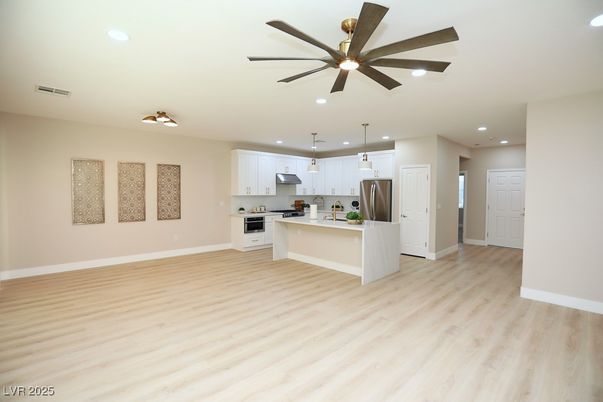 Empty room, Interior, Kitchen, Pendant Lights, Recessed Lighting, Stainless Steel Appliances, Wood Texture Flooring