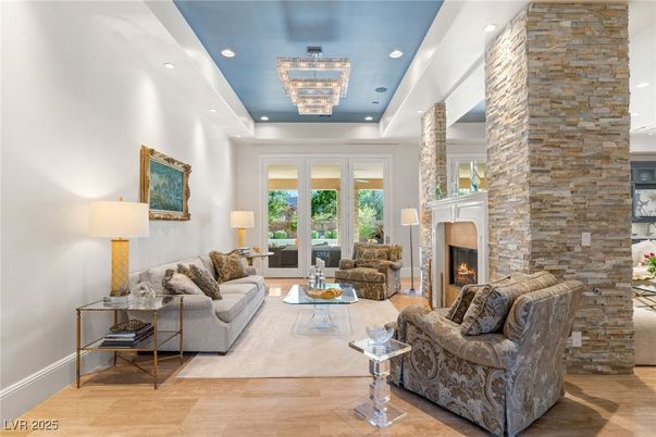 Chandelier, Fireplace, Interior, Living room, Recessed Lighting, Stone Walls, Wood Texture Flooring