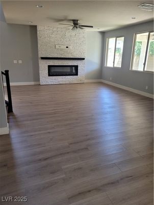 Empty room, Fireplace, Interior, Recessed Lighting, Stone Walls, Wood Texture Flooring