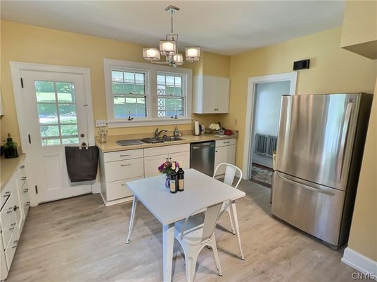 Chandelier, Dining room, Interior, Kitchen, Pendant Lights, Stainless Steel Appliances, Wood Texture Flooring