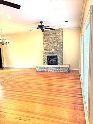 Chandelier, Fireplace, Interior, Recessed Lighting, Stone Walls, Wood Texture Flooring