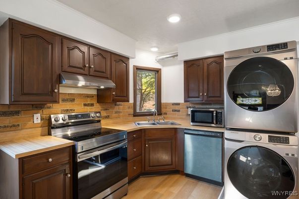 Interior, Kitchen, Recessed Lighting, Washer, Wood Texture Flooring