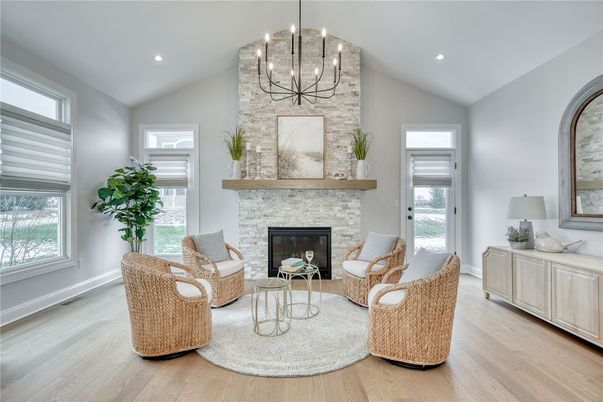Chandelier, Fireplace, Interior, Living room, Recessed Lighting, Stone Walls, Wood Texture Flooring