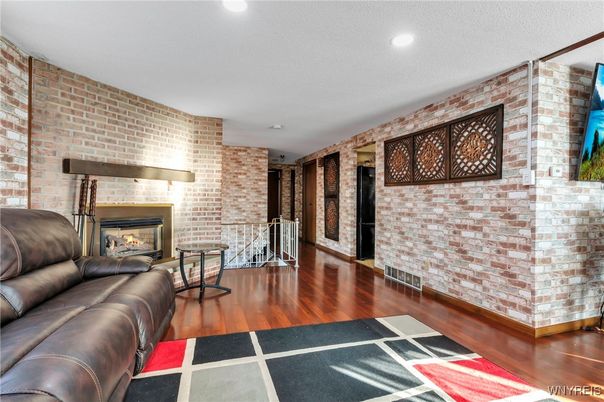 Fireplace, Interior, Living room, Recessed Lighting, Stone Walls, Wood Texture Flooring