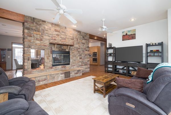 Fireplace, Interior, Living room, Recessed Lighting, Stone Walls, Wood Texture Flooring