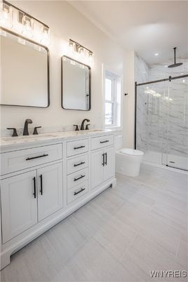 Bathroom, Dual Sink Vanities, Glass Shower, Interior, Marble Walls, Recessed Lighting